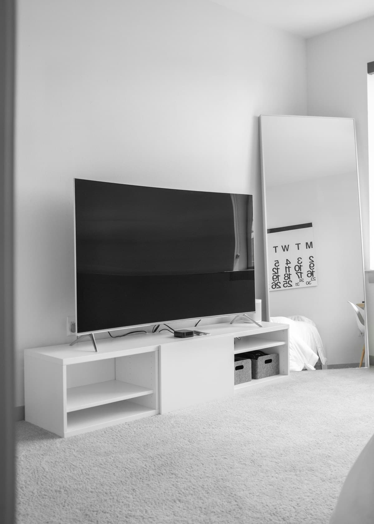 Flat screen TV on a stand — not yet professionally wall mounted